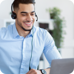 A call center employee speaks into a telephone headset. 